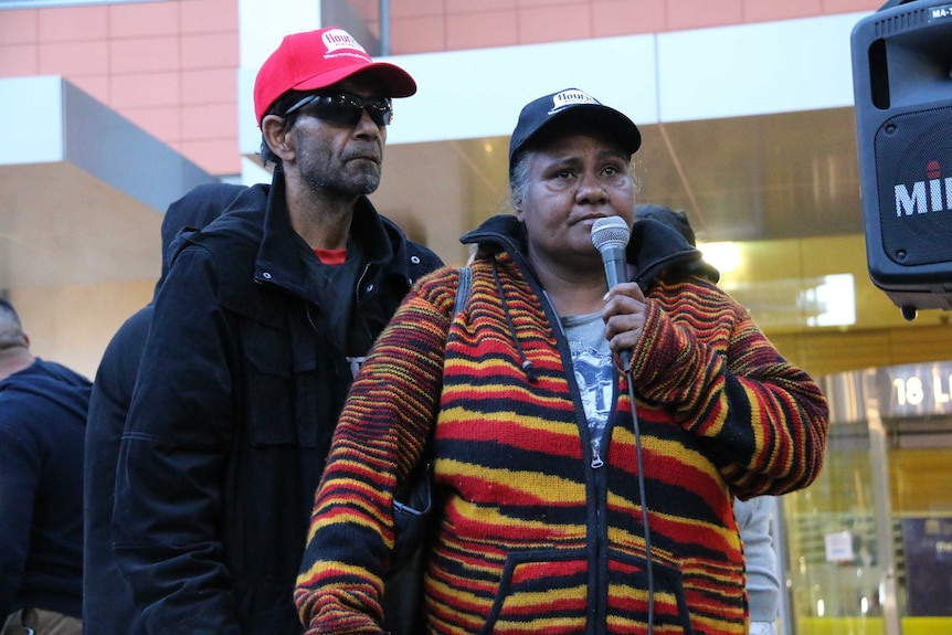 Colin and Nioka Chatfield address the crowd at a rally after the death of their son Tane in custody.