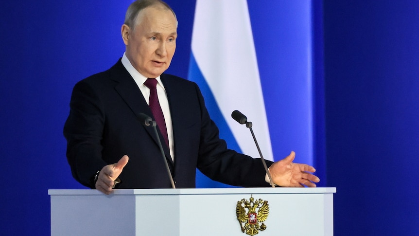 Russian President Vladimir Putin gestures as he gives his annual state of the nation address.