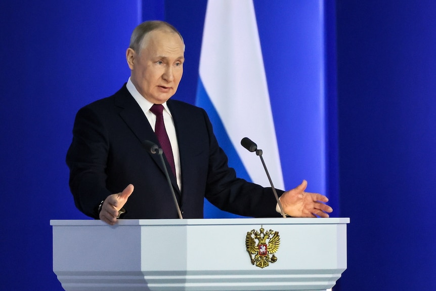 Russian President Vladimir Putin gestures as he gives his annual state of the nation address.