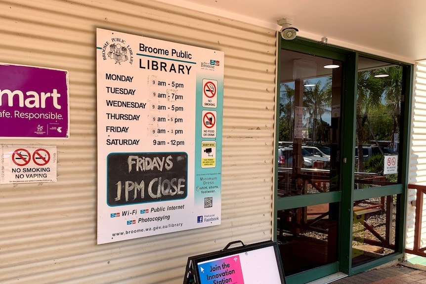 The front entry of a building with sign saying 'Fridays 1pm close'