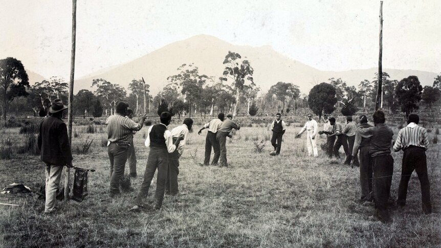 Photograph of Aboriginal men playing football in a paddock at Coranderrk Aboriginal Station, Victoria, 1904.