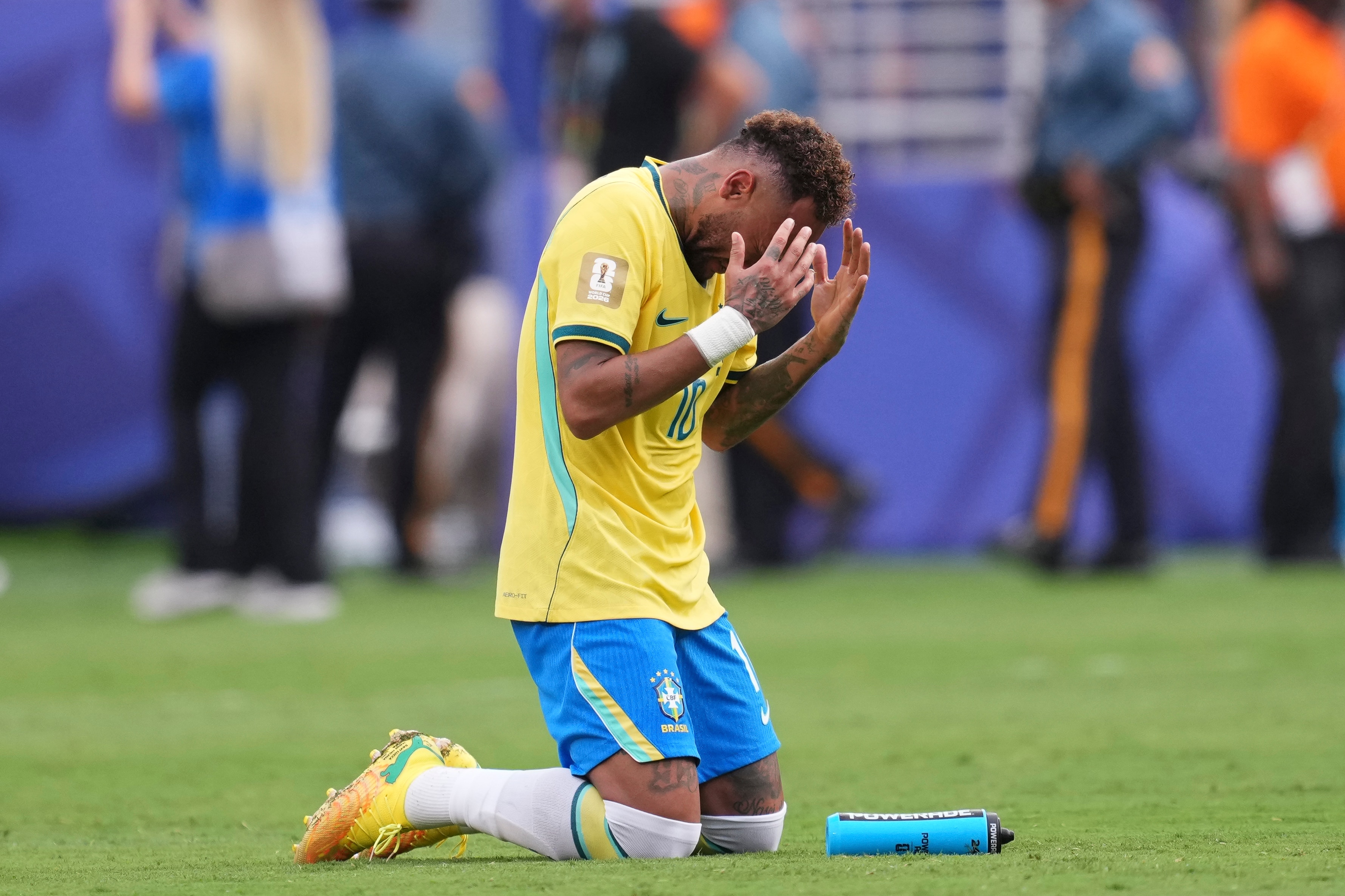 Neymar prays on his knees after his last Brazil game