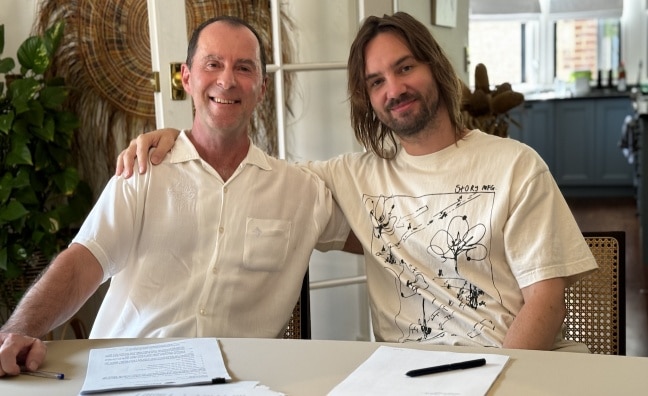 Sony Music Publishing's Damian Trotter and Tame Impala's Kevin Parker embrace over a contract