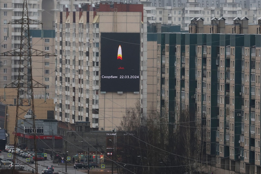 A billboard with a picture of a candle candle on the side of a building.