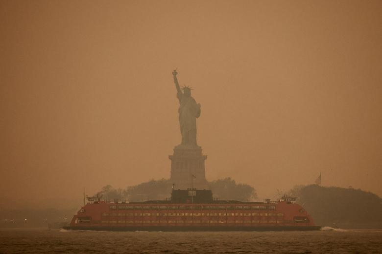 New York city's Statue of Liberty covered in orange haze and smoke