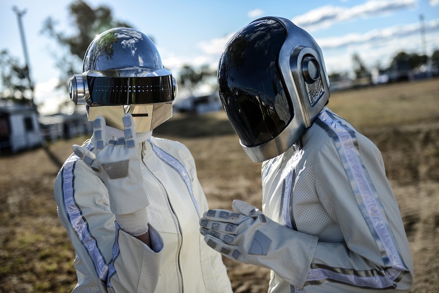 Two fans in Wee Waa show off their elaborate Daft Punk robot costumes bedecked in white and blue with helmets