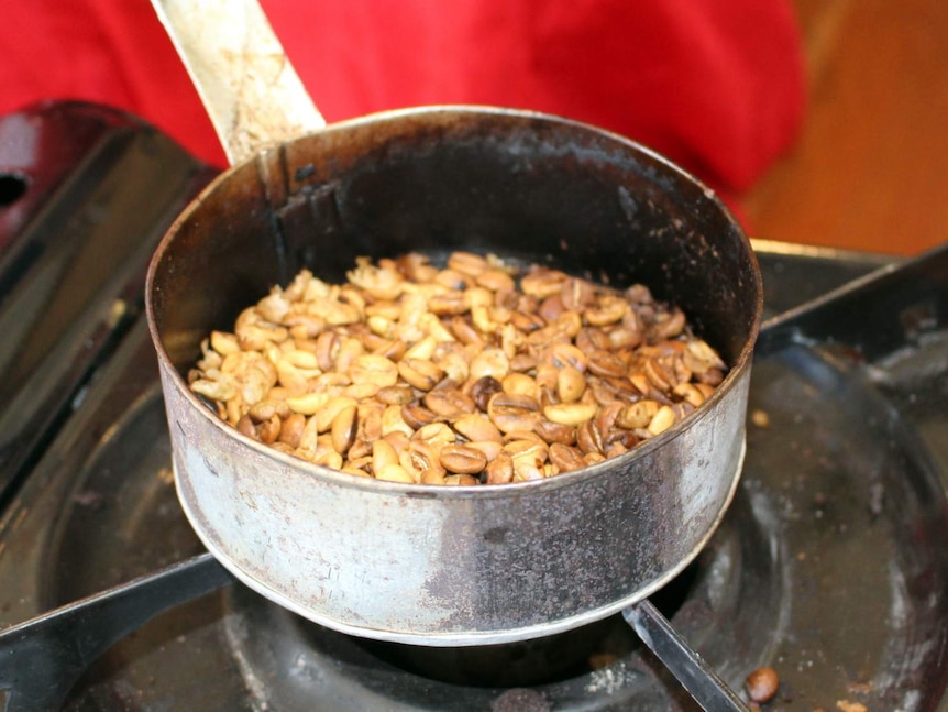 Ethiopian coffee beans roasting in a pan.