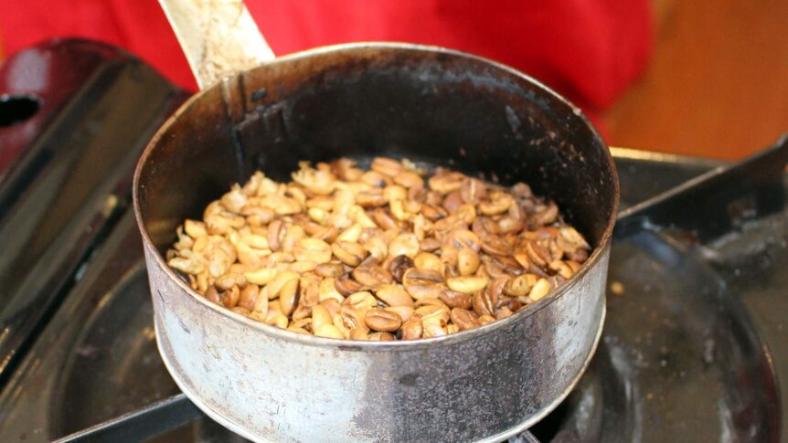 Ethiopian coffee beans roasting in a pan.