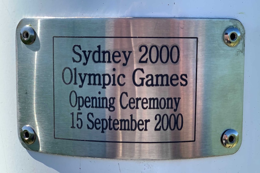 A plaque on the flagpole used in the opening ceremony at the Sydney Olympic Games that now resides at a farm in the NSW Riverina