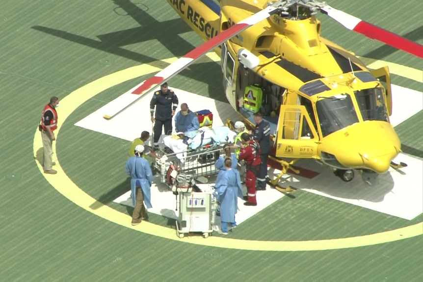 A patient in transported off a chopper on a stretcher