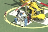 A patient in transported off a chopper on a stretcher
