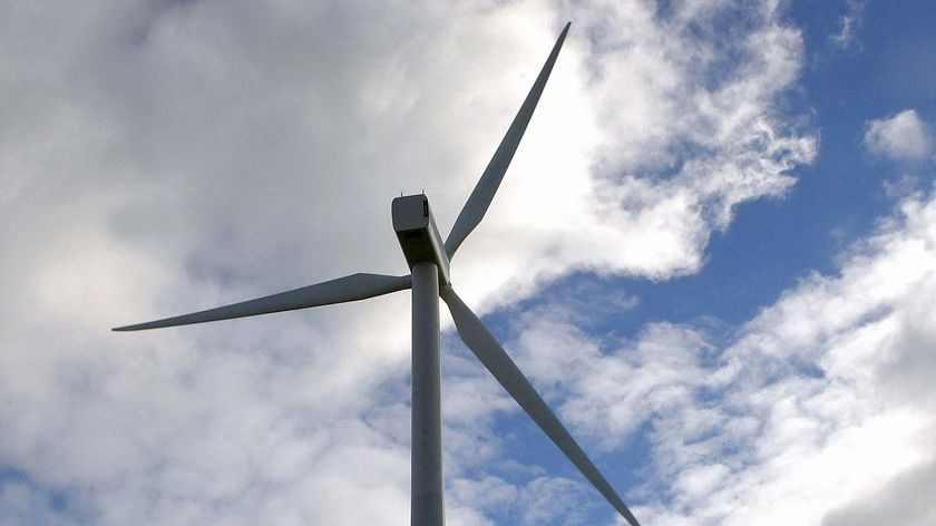 Wind turbine against skyline