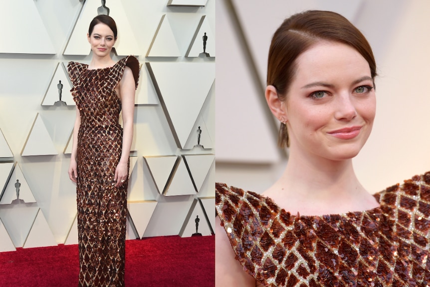 Emma Stone wears a red and orange, sequined dress with structured shoulders.