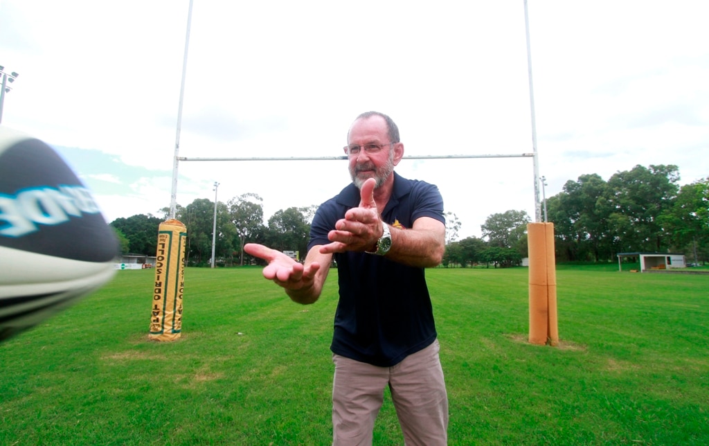 A man preparing to catch a football on a field