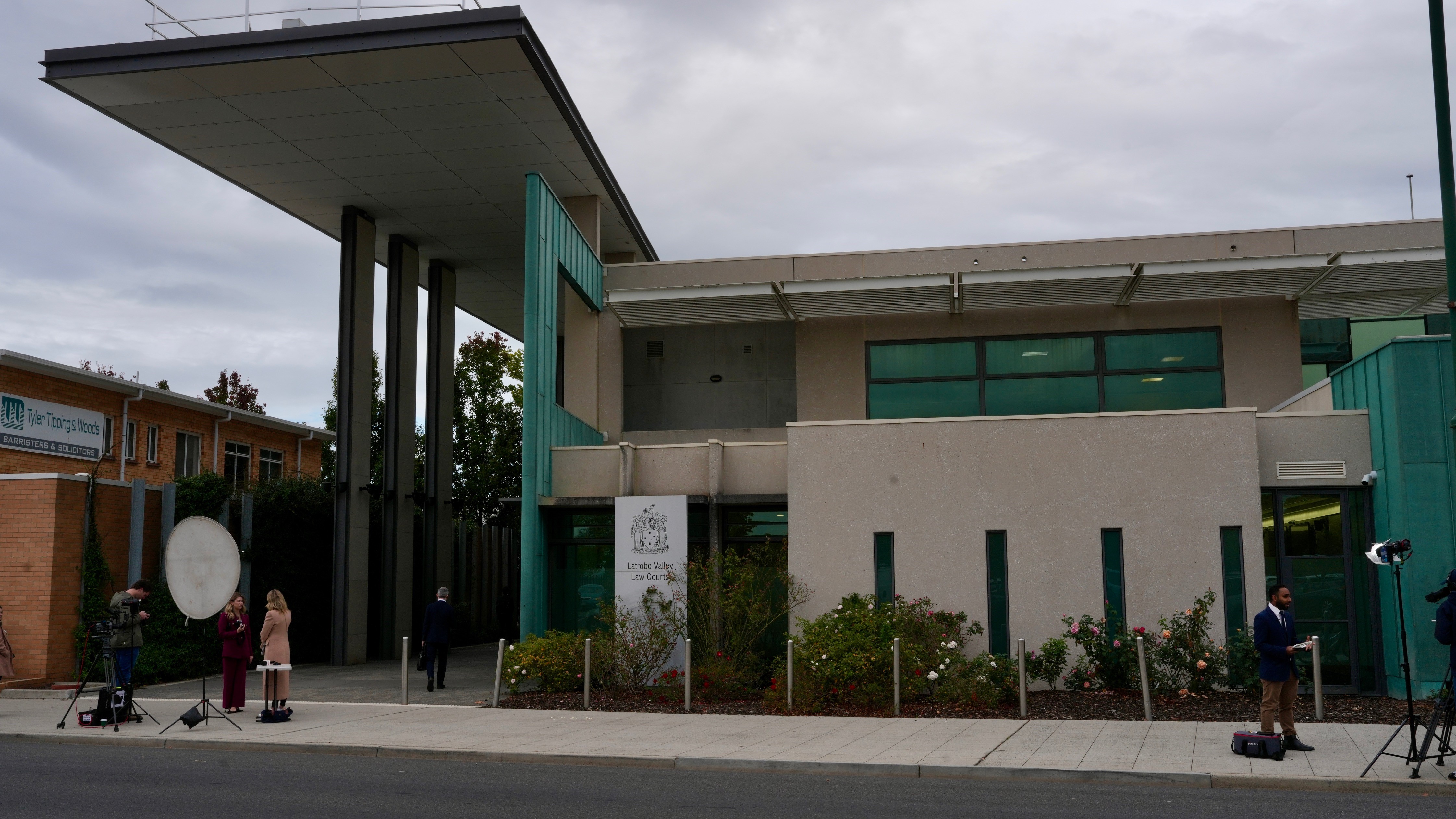 Media stand outside the Latrobe Valley court house in Morwell doing television crosses.