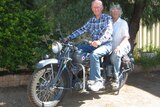 Older couple on a vintage motorbike