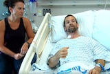 Colin Dowler in a hospital bed in Vancouver next to his wife Jennifer.