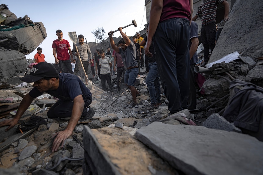 people digging among rubble
