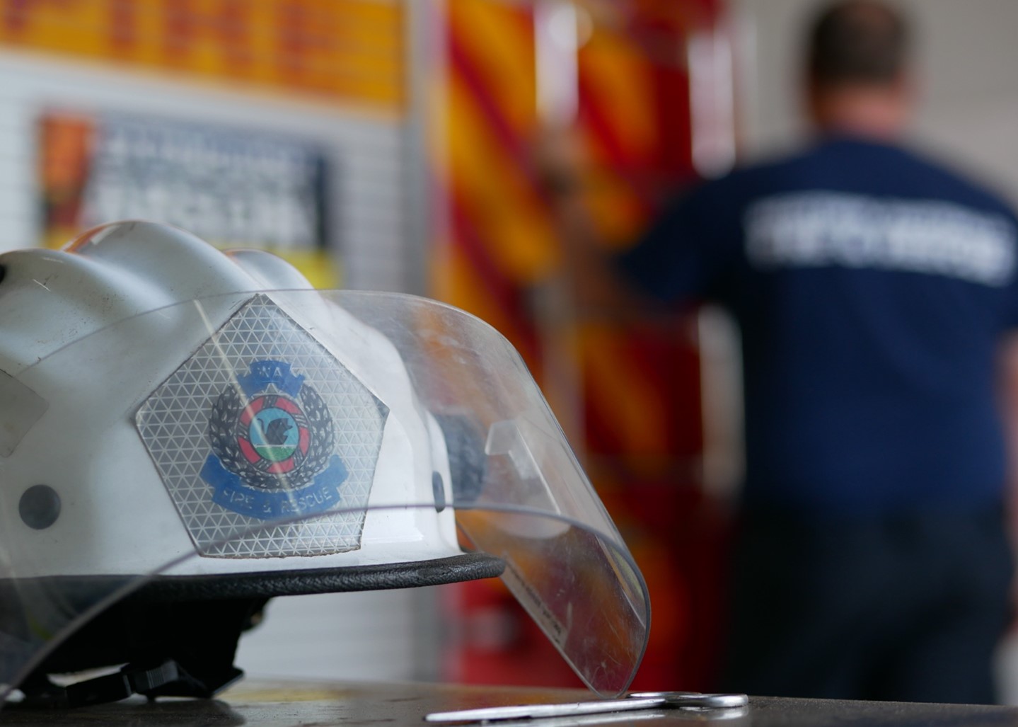 Anonymous shot of a firefighter holding his helmet