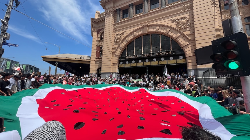 Students outside Flinders Street with a large watermelon banner.