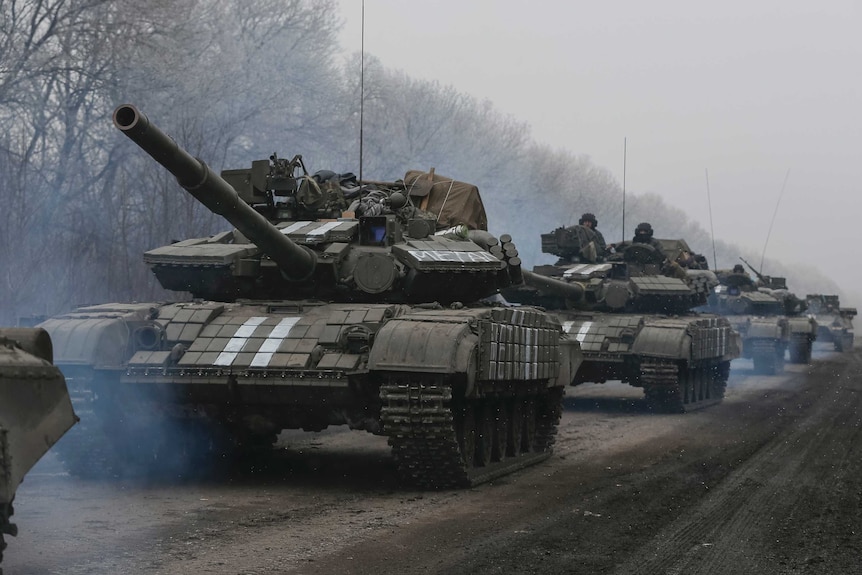 Ukrainian servicemen ride on a tank near Debaltseve