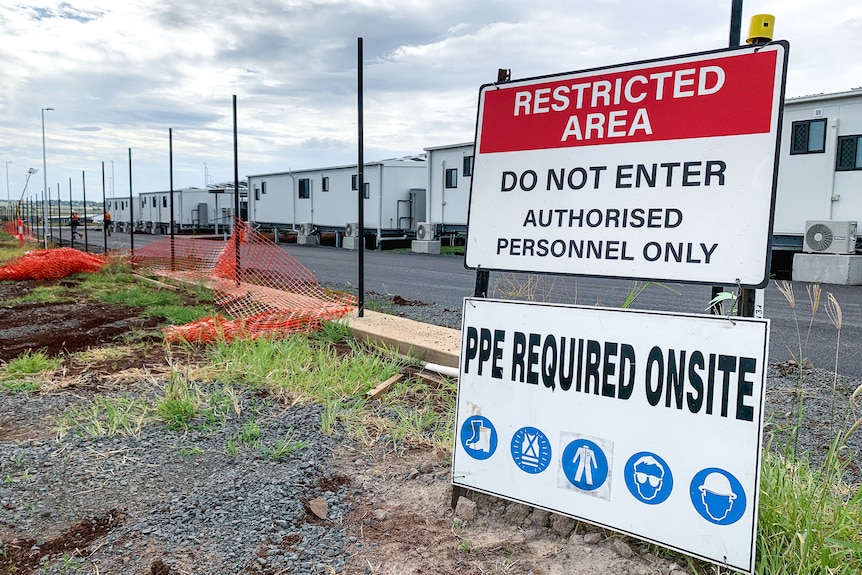 A sign reading 'Restricted Area' in front of a construction zone