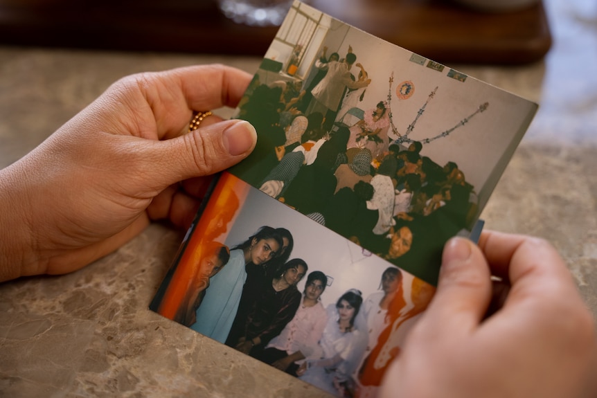 Female hands holding two photographs