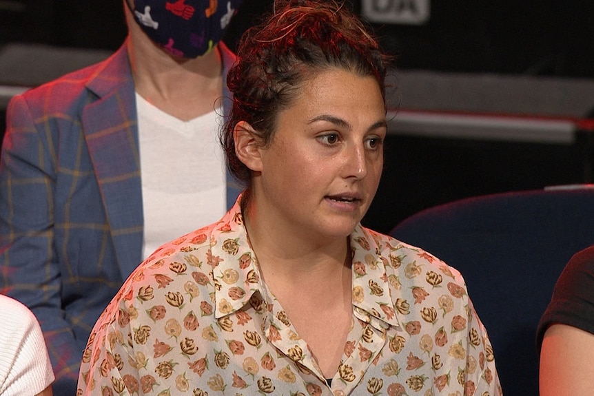 A woman in an open neck shirt appears on Q+A.