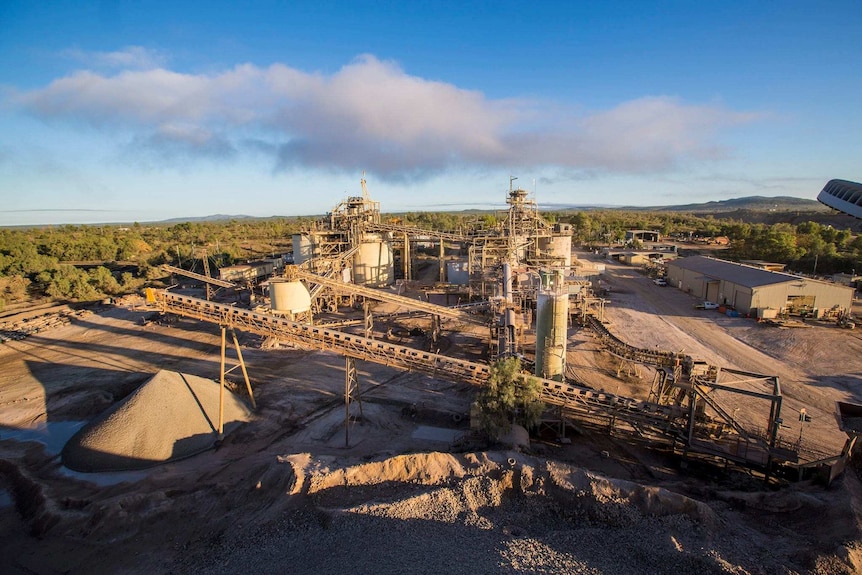 A gold mine with buildings and a conveyer belt