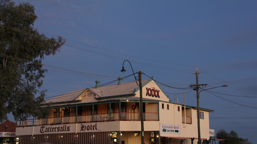 An outback two storey timber hotel at sunset