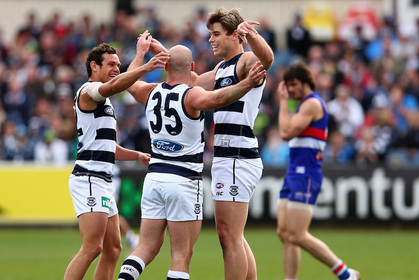 Geelong players celebrate another goal in their 34-point victory over the Western Bulldogs.
