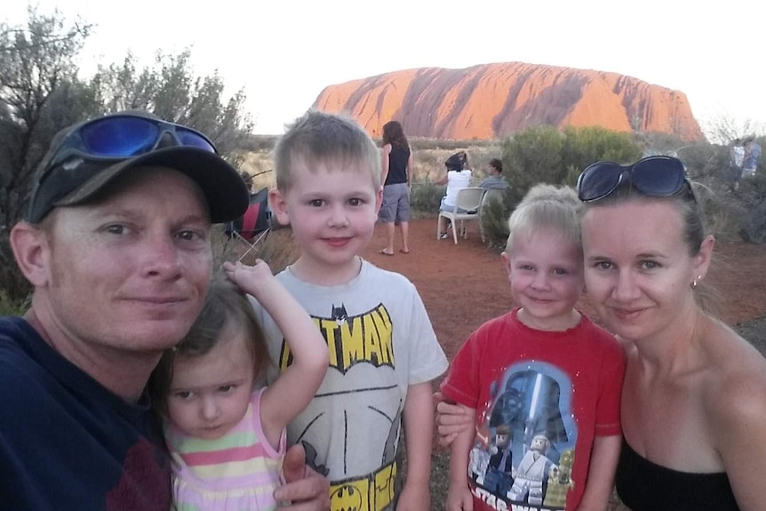 A family in front of Uluru.