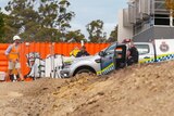 Tasmania Police officers at Hutchins construction site where bones were found after excavations unearthed a historical grave