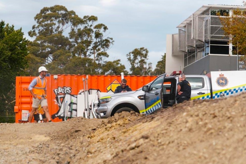 Tasmania Police officers at Hutchins construction site where bones were found after excavations unearthed a historical grave