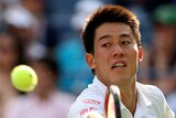Kei Nishikori stretches for a backhand at the US Open