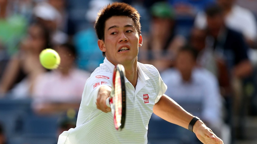 Kei Nishikori stretches for a backhand at the US Open