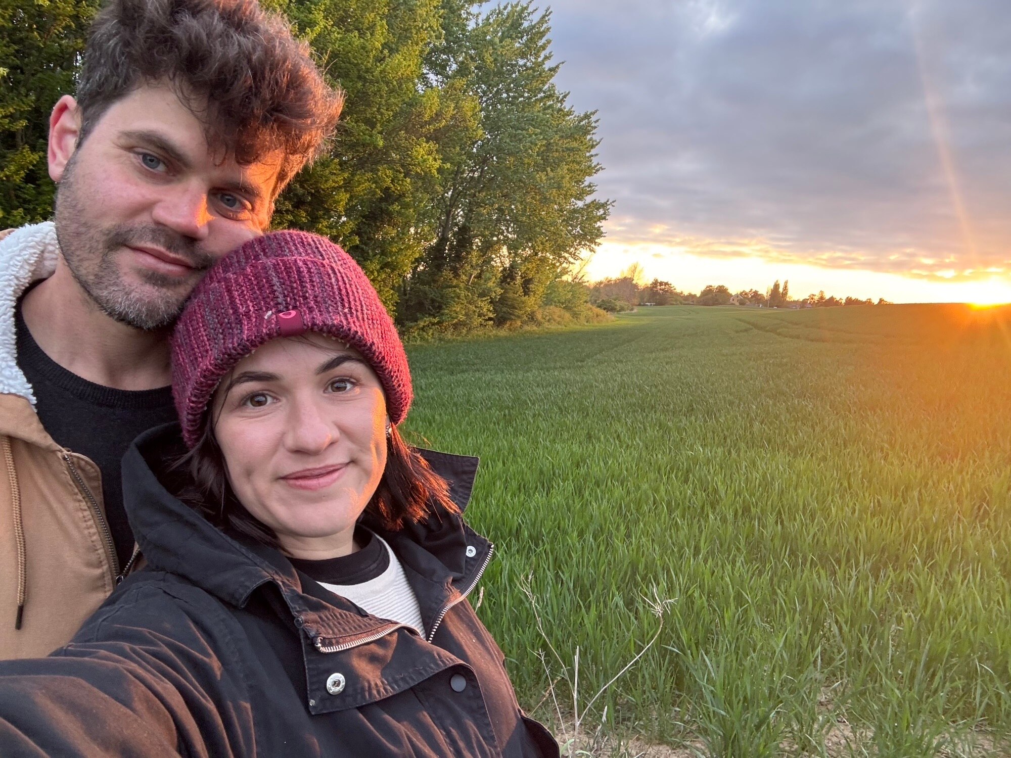 Claire Jensen and her husband take a selfie in a field