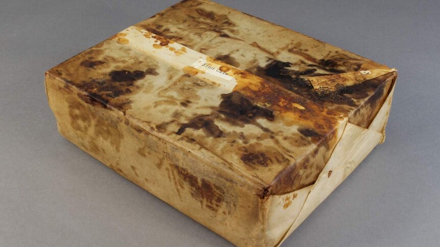 Hundred-year-old fruitcake wrapped in paper.