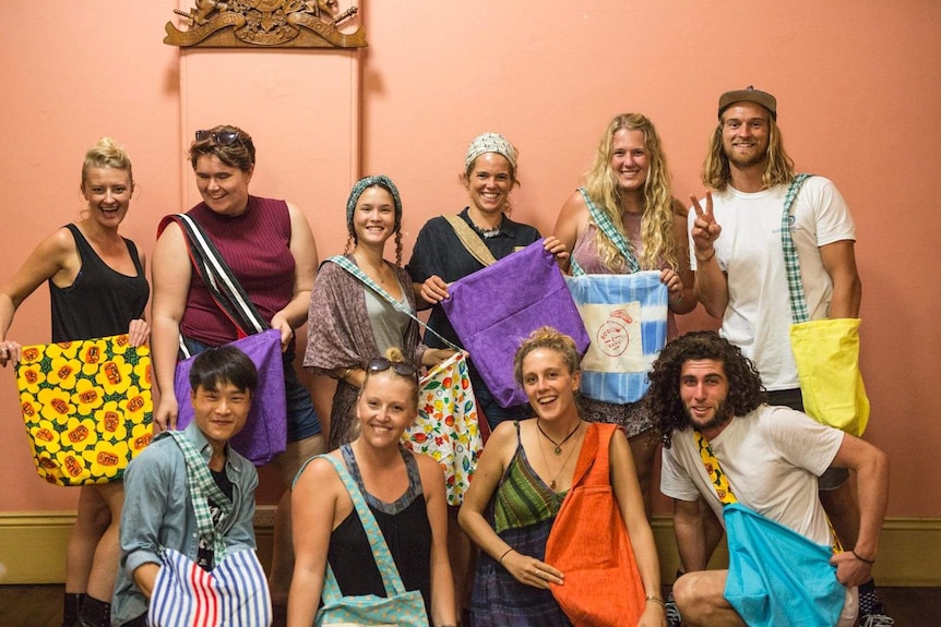 Volunteers stand with freshly made Boomerang Bags in Wollongong.