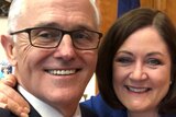 Sarah Henderson puts her arm around Malcolm Turnbull as they smile for a selfie
