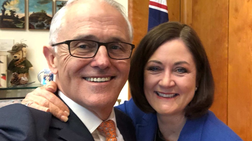 Sarah Henderson puts her arm around Malcolm Turnbull as they smile for a selfie