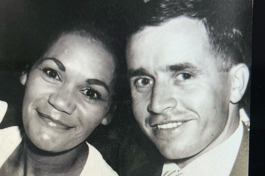Lorraine and Harry Peeters smile at the camera in a black and white photo