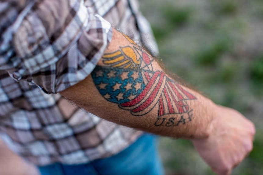 A man's forearm with a US flag on it