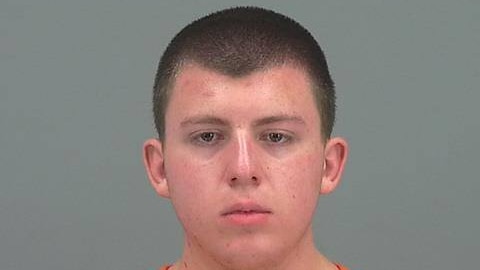 The mugshot of an 18-year-old American man