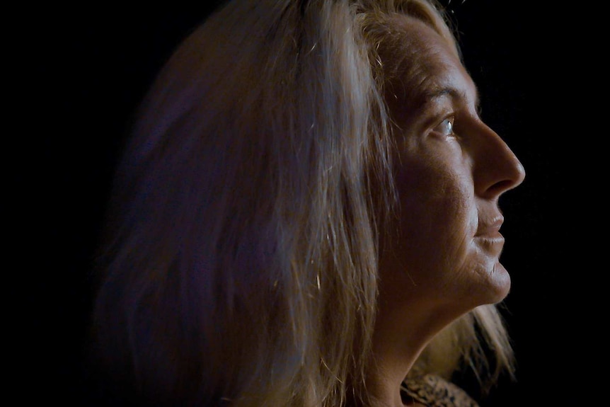 Nicola Gobbo in profile, half her face obscured by shadow.