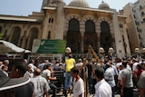 Anti-Morsi protesters and riot police officers gather outside al-Fath mosque in Cario