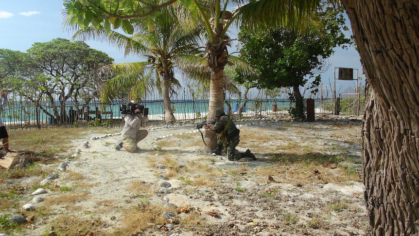 Filipino marines being filmed in the Spratly Islands.