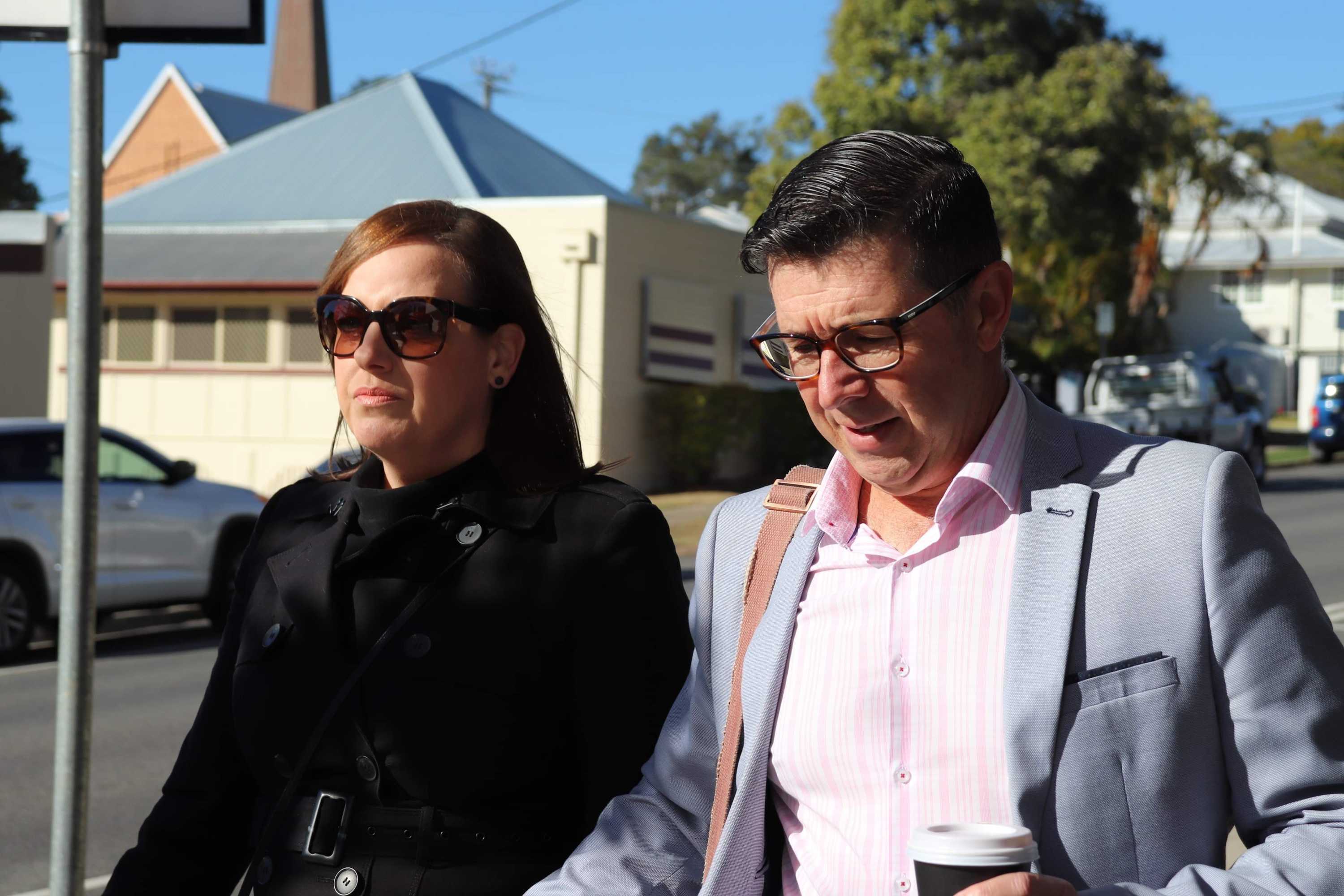 Former Ipswich mayor Andrew Antoniolli walks with his wife.
