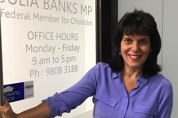 Woman standing by office door