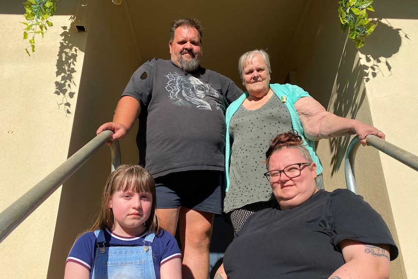 Four members of the Patullo family sit on the family's verandah.